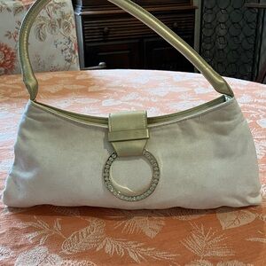Chic Cream Shoulder Bag with Silver Ring Detail and golden handle.